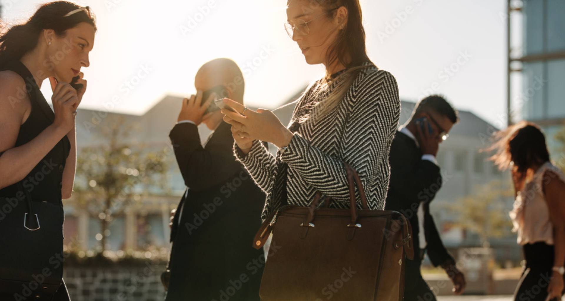 A woman busy in mobile while walking