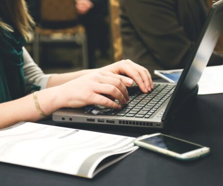 A woman working on laptop in office