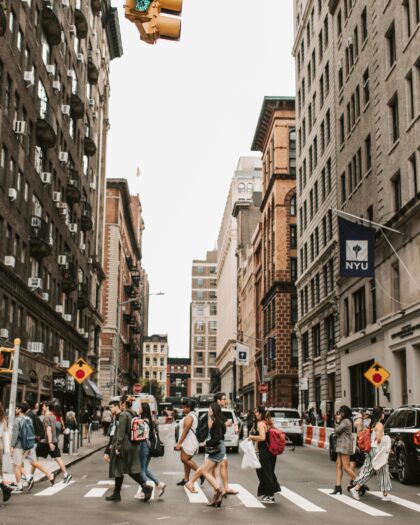 people crossing city cross-walk at NYU
