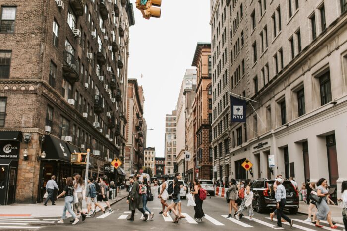 people crossing city cross-walk at NYU