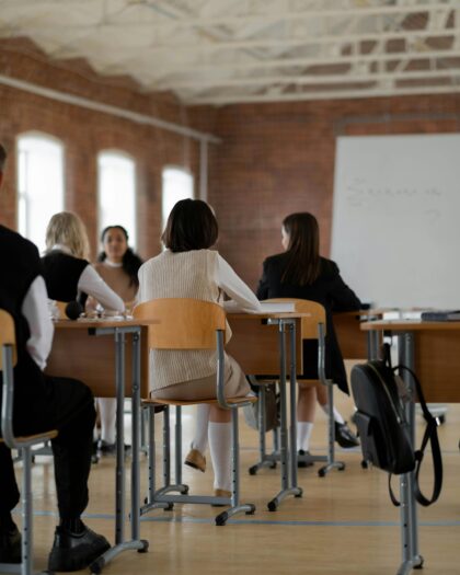business students sitting in classroom facing whiteboard