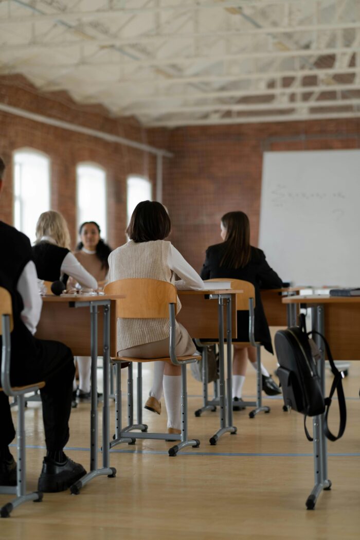 business students sitting in classroom facing whiteboard