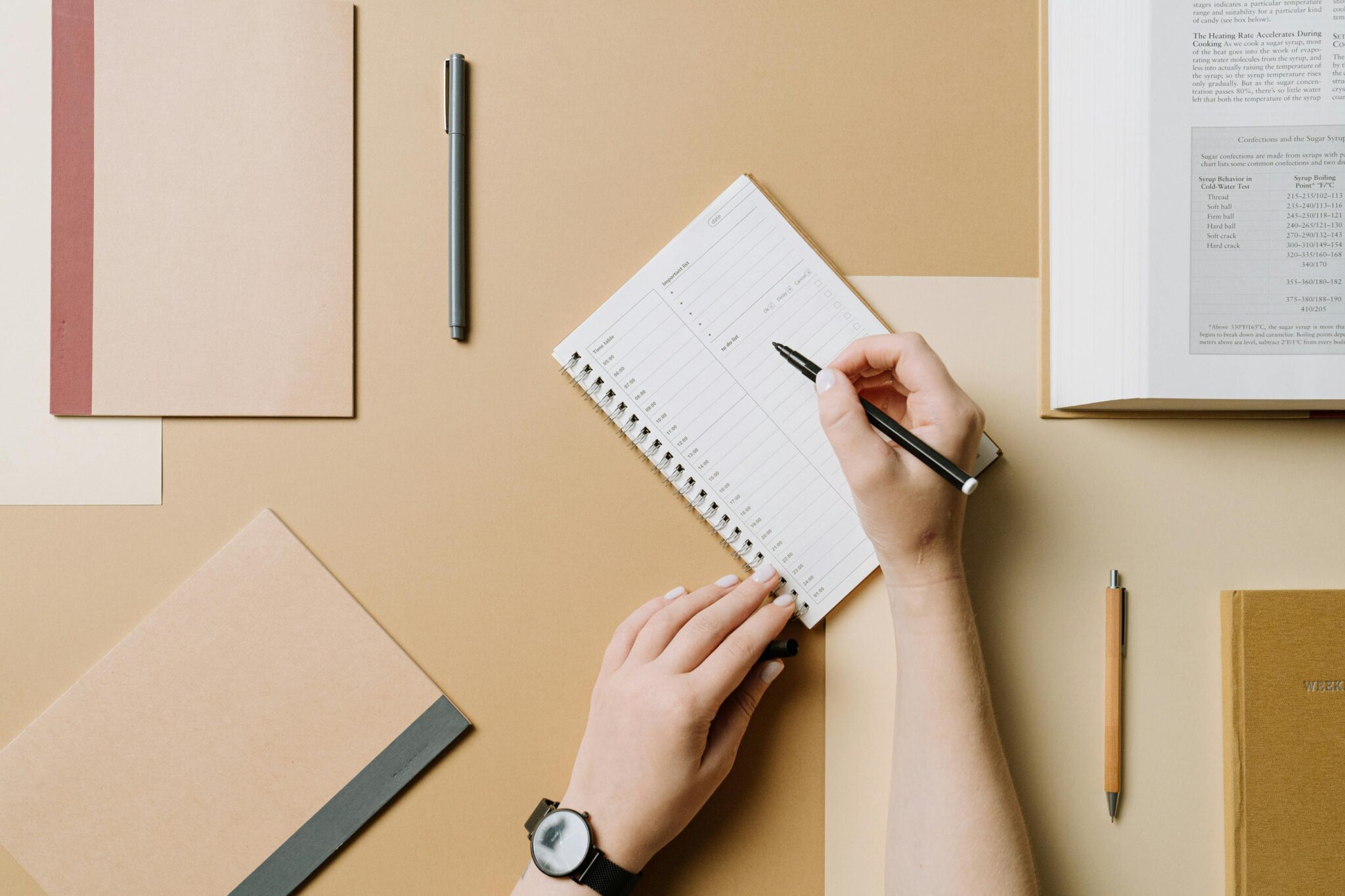 Hand writing notes on small notebook