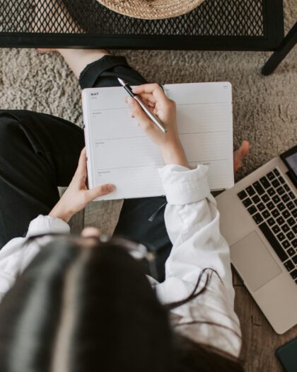 arial shot of woman writing on agenda planner