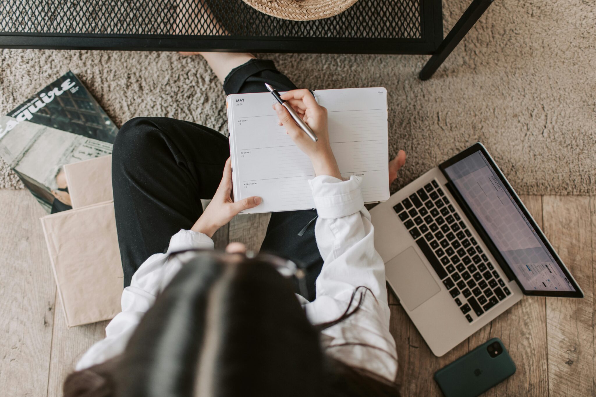 arial shot of woman writing on agenda planner