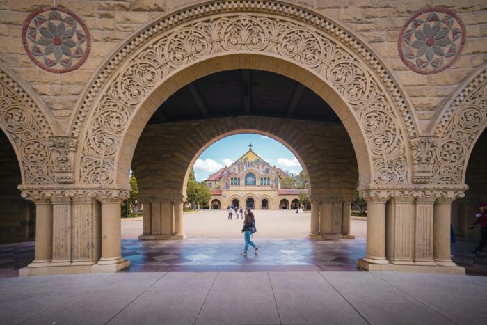 Female student standing in Stanford Law School courtyard, looking back at the camera.