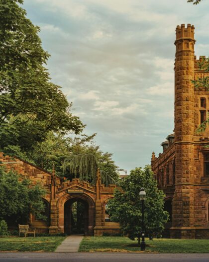 Old Princeton University buildings surrounded by green trees and foliage