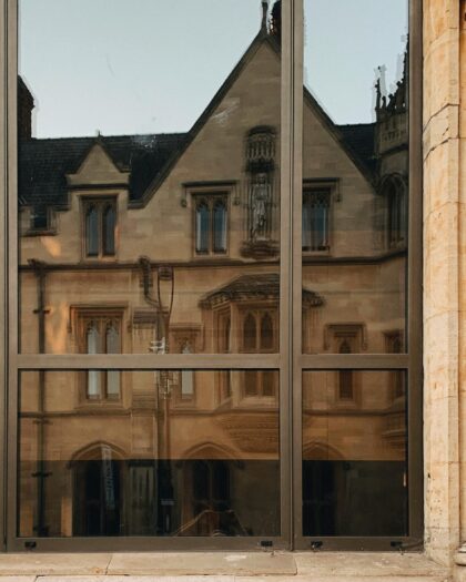 Reflection of old English building in window