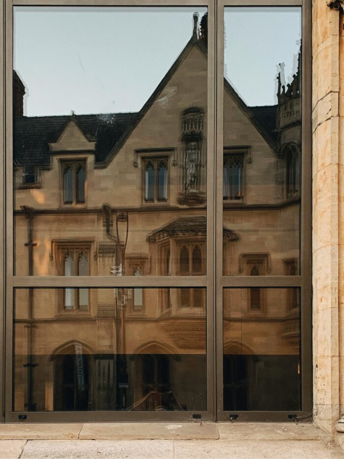 Reflection of old English building in window
