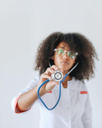 Doctor holding a stethoscope towards the camera