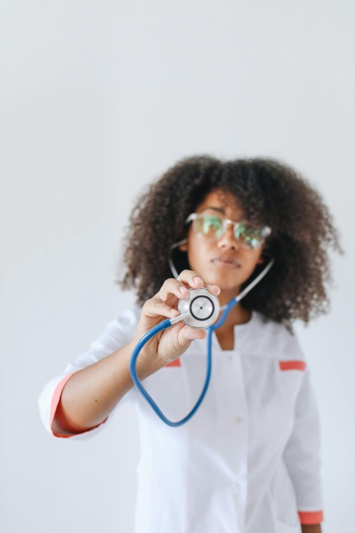 Doctor holding a stethoscope towards the camera