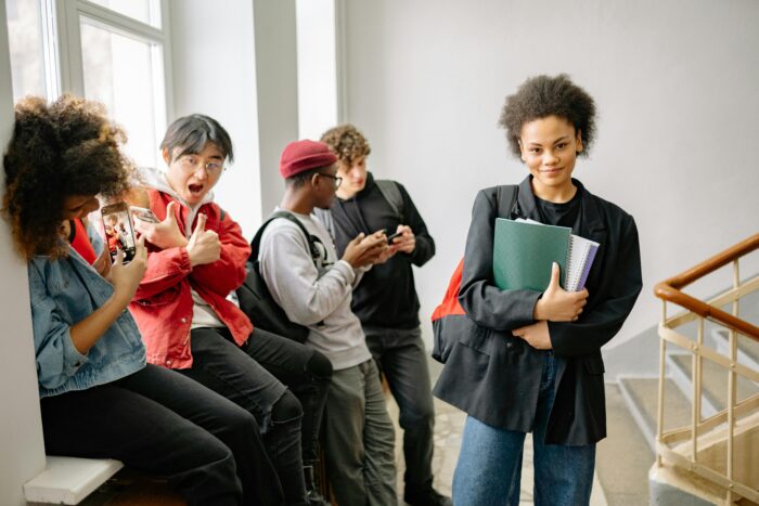 Diverse group of college students hanging out near window