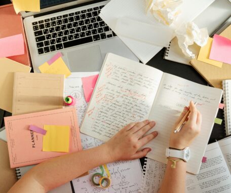 Person Writing on a Notebook