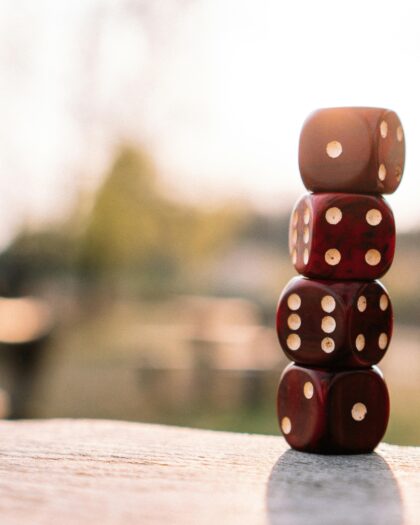 Four dice stacked atop one another on an outdoor table