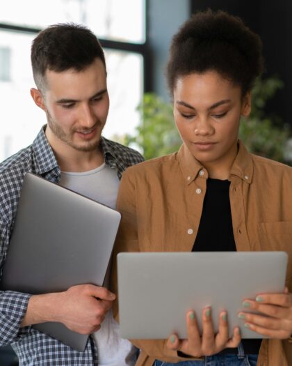 Man in Brown Blazer Holding White Tablet Computer