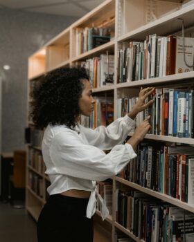 Woman looking for a book in a library