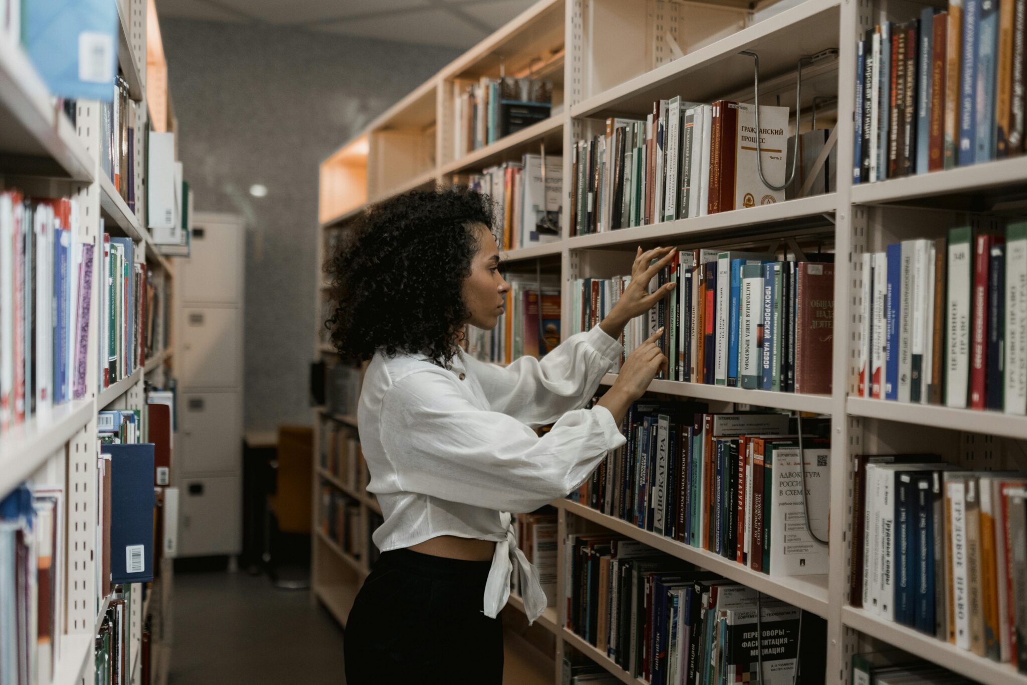 Woman looking for a book in a library