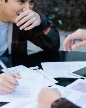 A Man in Plaid Long Sleeves Studying