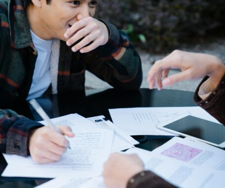 A Man in Plaid Long Sleeves Studying
