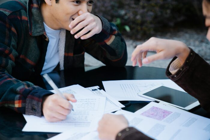 A Man in Plaid Long Sleeves Studying