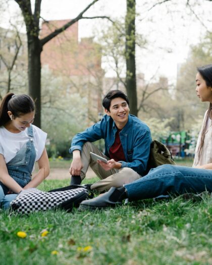 Photo of a Group of Friends Sitting on the Grass