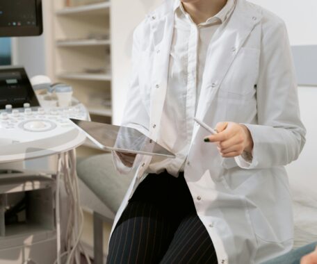 Photo Of Gynecologist Sitting Near Medical Equipment