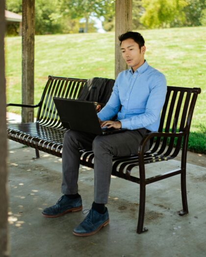 Man Working on a Bench in a Park
