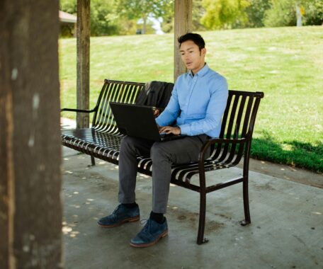 Man Working on a Bench in a Park