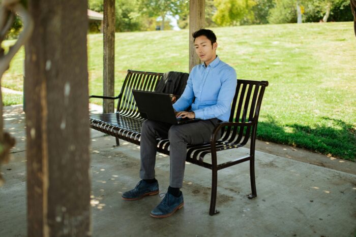 Man Working on a Bench in a Park