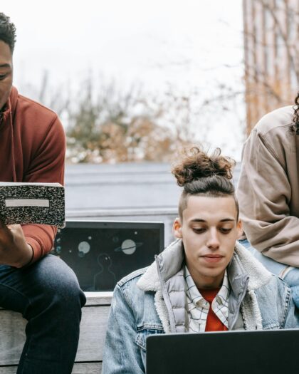Multiethnic group of young people studying with notebook and laptop