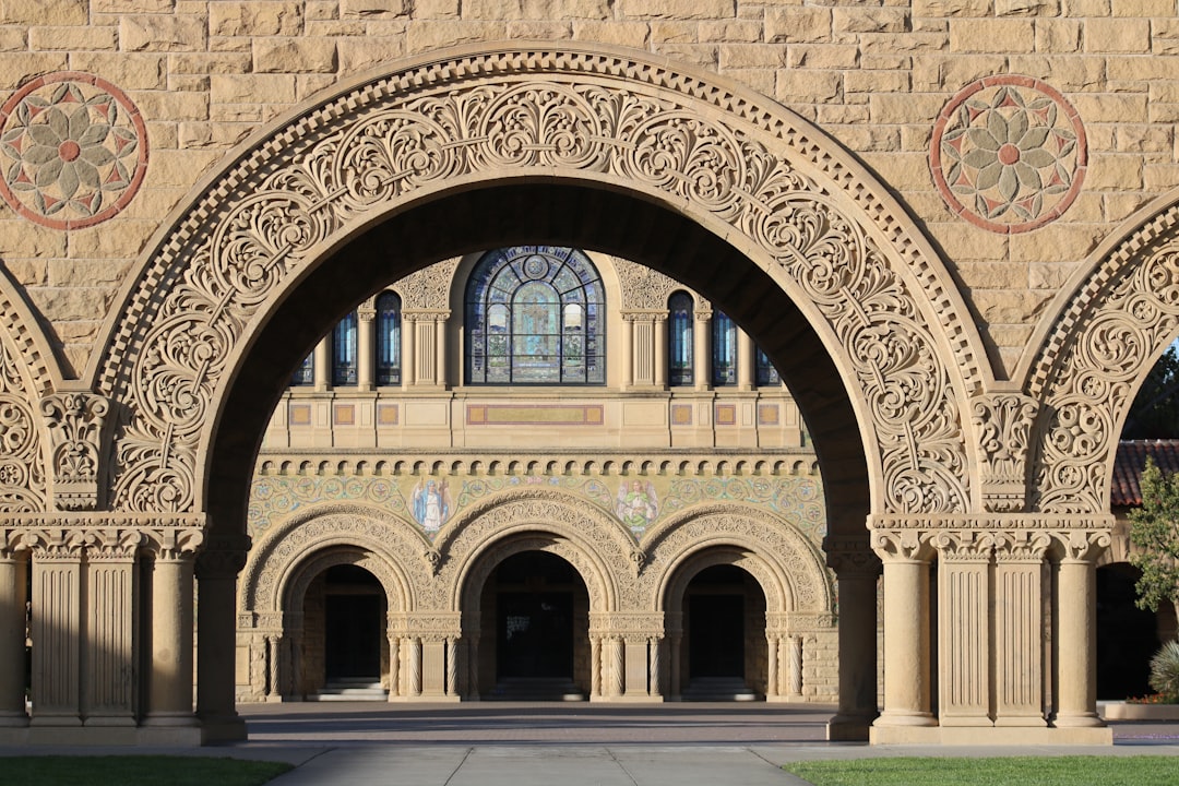 A large stone building featuring multiple arches and intricate architectural details.
