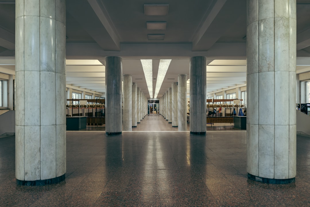 a large room with columns and a long hallway