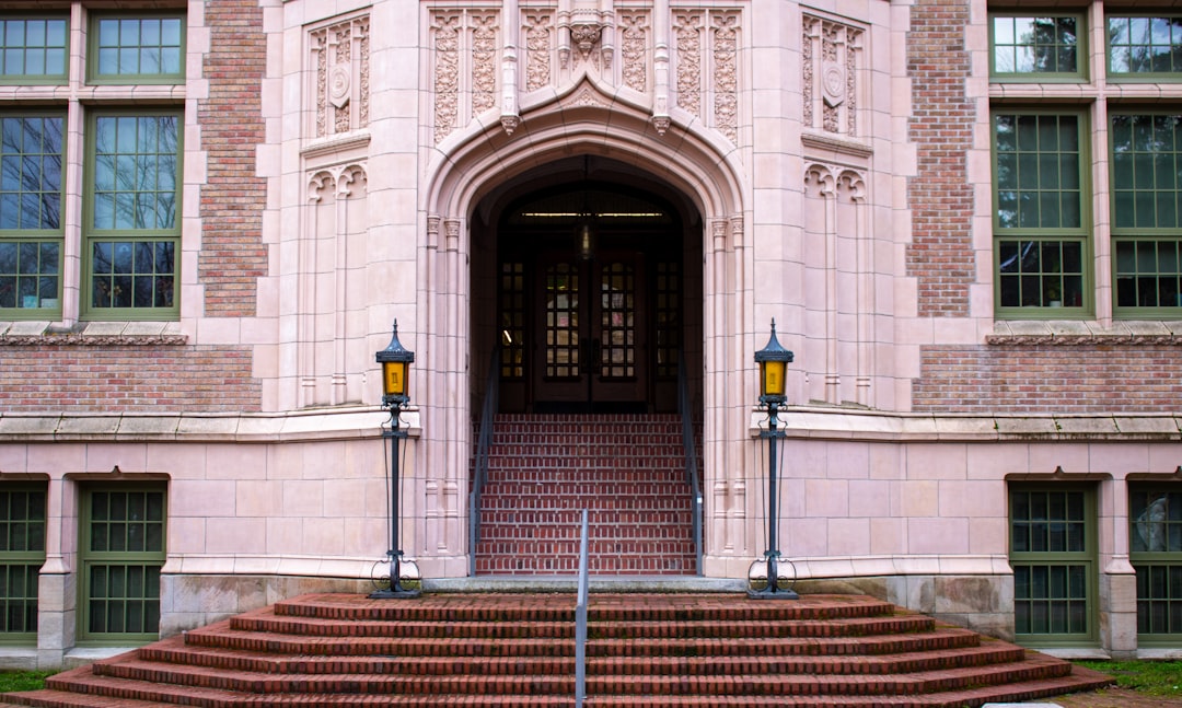 A grand arched entrance with steps and lamps.