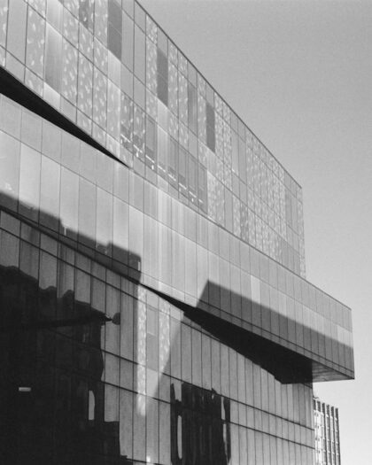 A modern building reflects the sun's bright light.