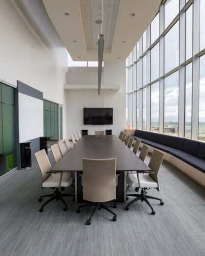 rectangular brown wooden table with chair lot inside building